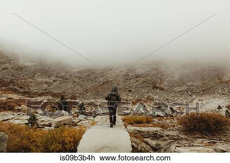 Rear view of male hiker hiking in misty valley, Mineral King, Sequoia National Park, California, USA View Large Photo Image Stock Image - Rear view of male hiker hiking in misty valley, Mineral King, Sequoia National Park, California, USA. Fotosearch