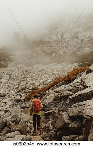 Stock Image - Rear view of male hiker hiking in rocky valley, Mineral King, Sequoia National Park, California, USA. Fotosearch