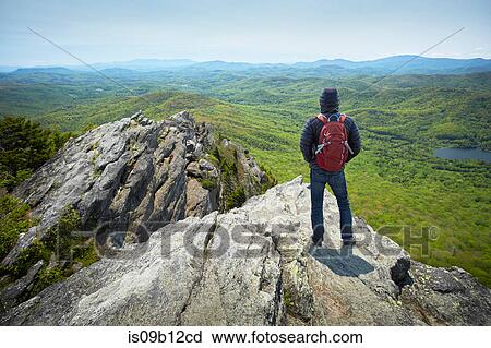 Rear view of male hiker looking out from ridge, Blue Ridge Mountains, North Carolina, USA View Large Photo Image Stock Image - Rear view of male hiker looking out from ridge, Blue Ridge Mountains, North Carolina, USA. Fotosearch