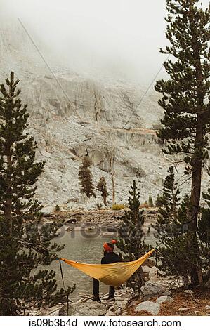 Rear view of male hiker sitting in hammock by lake, Mineral King, Sequoia National Park, California, USA View Large Photo Image Stock Image - Rear view of male hiker sitting in hammock by lake, Mineral King, Sequoia National Park, California, USA. Fotosearch