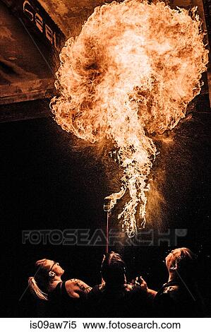 Rear view of performers fire breathing View Large Photo Image Stock Photography - Rear view of performers fire breathing. Fotosearch