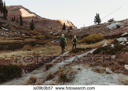 Stock Photo - Rear view of two male hikers hiking up rugged landscape, Mineral King, Sequoia National Park, California, USA. Fotosearch