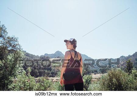 Rear view of woman in the mountains looking away, Malibu, California, USA View Large Photo Image Stock Photo - Rear view of woman in the mountains looking away, Malibu, California, USA. Fotosearch