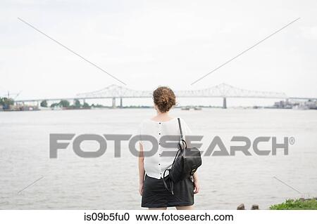 Rear view of woman looking at New orleans bridge, Mississippi river, French Quarter, New Orleans, Louisiana, USA View Large Photo Image Stock Image - Rear view of woman looking at New orleans bridge, Mississippi river, French Quarter, New Orleans, Louisiana, USA. Fotosearch