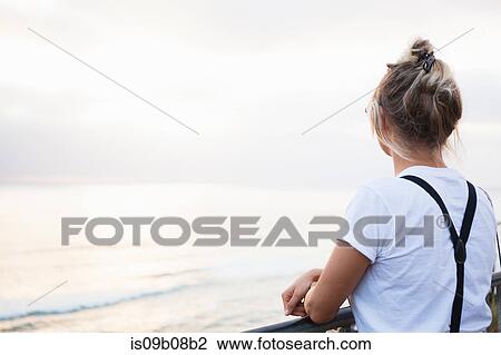 Rear view of woman looking at ocean, Encinitas, California, USA View Large Photo Image Stock Image - Rear view of woman looking at ocean, Encinitas, California, USA. Fotosearch