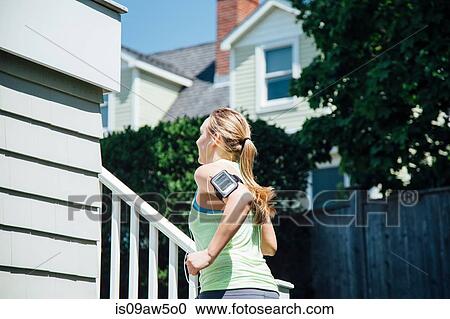 Rear view of woman wearing activity tracker running up stairs View Large Photo Image Stock Image - Rear view of woman wearing activity tracker running up stairs. Fotosearch