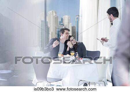 Romantic young couple ordering breakfast in hotel restaurant View Large Photo Image Stock Image - Romantic young couple ordering breakfast in hotel restaurant. Fotosearch