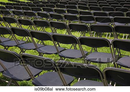 Rows of folding chairs on grass View Large Photo Image Stock Image - Rows of folding chairs on grass. Fotosearch
