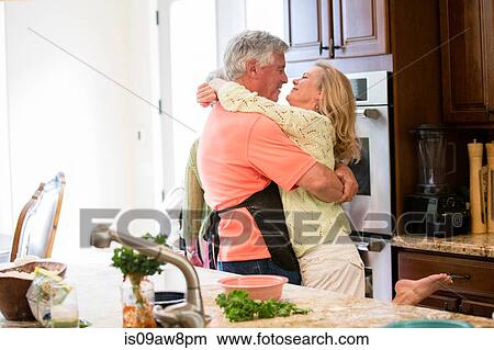 Senior couple hugging in kitchen View Large Photo Image Picture - Senior couple hugging in kitchen. Fotosearch