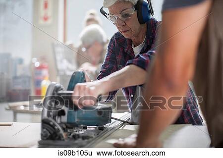Senior female carpenter using power saw in furniture making workshop View Large Photo Image Stock Photograph - Senior female carpenter using power saw in furniture making workshop. Fotosearch