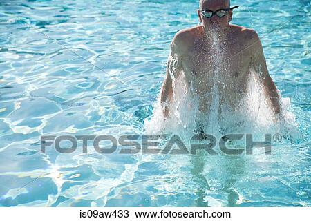 Senior man emerging from water in outdoor swimming pool View Large Photo Image Stock Image - Senior man emerging from water in outdoor swimming pool. Fotosearch