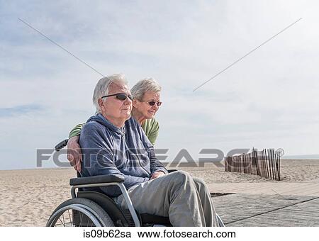 Senior man in wheelchair with wife at beach, Santa Monica, California, USA View Large Photo Image Stock Image - Senior man in wheelchair with wife at beach, Santa Monica, California, USA. Fotosearch