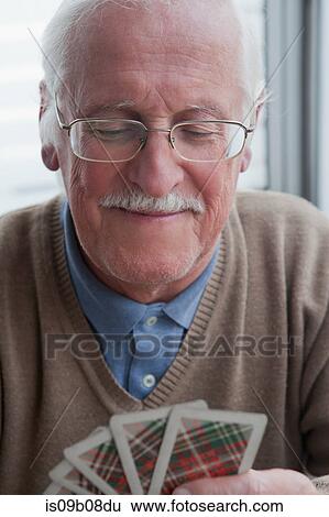 Senior man playing cards at home View Large Photo Image Stock Photograph - Senior man playing cards at home. Fotosearch