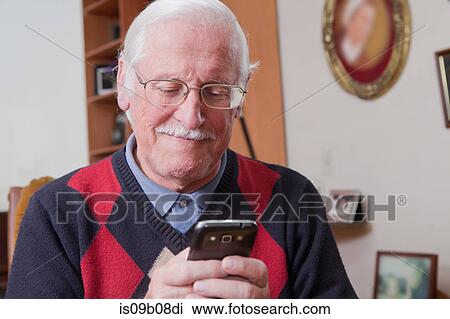 Senior man using mobile phone at home View Large Photo Image Stock Image - Senior man using mobile phone at home. Fotosearch