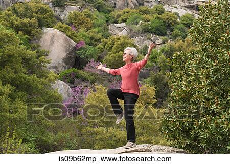 Stock Photography - Senior woman doing yoga, Sequoia National Park, California, US. Fotosearch