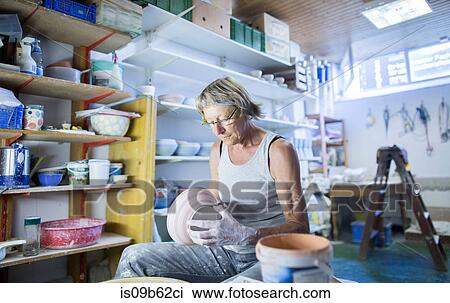 Senior woman in pottery workshop, inspecting bowl View Large Photo Image Stock Image - Senior woman in pottery workshop, inspecting bowl. Fotosearch