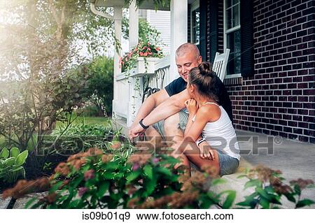 Side view of father and daughter sitting on porch chatting View Large Photo Image Stock Photo - Side view of father and daughter sitting on porch chatting. Fotosearch