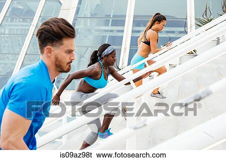 Side view of man and two women training, running up stairway at sport facility, downtown San Diego, California, USA View Large Photo Image Stock Photograph - Side view of man and two women training, running up stairway at sport facility, downtown San Diego, California, USA. Fotosearch