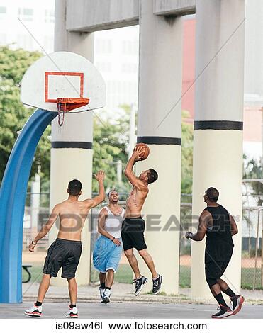 Side view of man in mid air holding basketball jumping for hoop View Large Photo Image Stock Image - Side view of man in mid air holding basketball jumping for hoop. Fotosearch