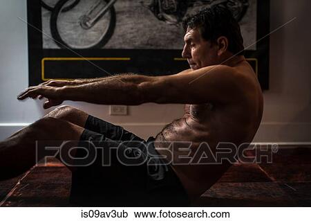 Side view of mature man on floor, arms out doing sit up View Large Photo Image Stock Image - Side view of mature man on floor, arms out doing sit up. Fotosearch