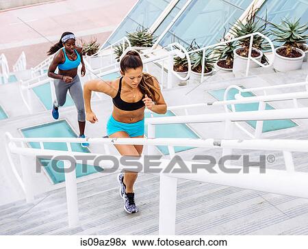 Side view of two women training, running up stairway at sport facility, downtown San Diego, California, USA View Large Photo Image Stock Photo - Side view of two women training, running up stairway at sport facility, downtown San Diego, California, USA. Fotosearch