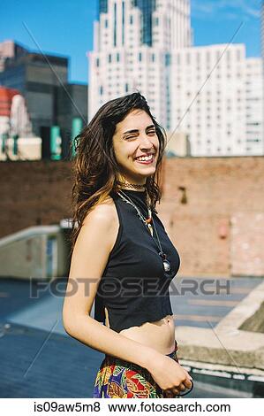 Side view of woman with nose ring on rooftop wearing crop top looking at camera eyes closed, smiling, Boston, Massachusetts, USA View Large Photo Image Stock Photo - Side view of woman with nose ring on rooftop wearing crop top looking at camera eyes closed, smiling, Boston, Massachusetts, USA. Fotosearch