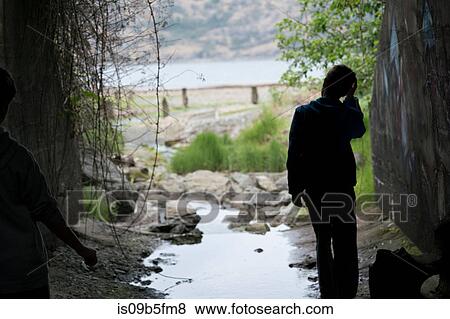 Silhouette of boy in sewer, Pacific Rim National Park, Vancouver Island, Canada View Large Photo Image Stock Photo - Silhouette of boy in sewer, Pacific Rim National Park, Vancouver Island, Canada. Fotosearch