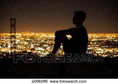 Stock Photograph - Silhouette of jogger on bench looking away at view, Runyon Canyon, Los Angeles, California, USA. Fotosearch