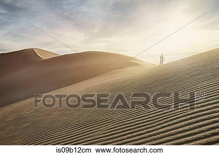 Silhouetted woman on top of dune at Great Sand Dunes National Park, Colorado, USA View Large Photo Image Picture - Silhouetted woman on top of dune at Great Sand Dunes National Park, Colorado, USA. Fotosearch