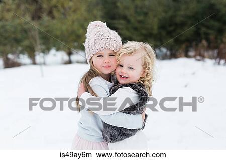 Sisters in snow-covered park, Oshawa, Canada View Large Photo Image Picture - Sisters in snow-covered park, Oshawa, Canada. Fotosearch
