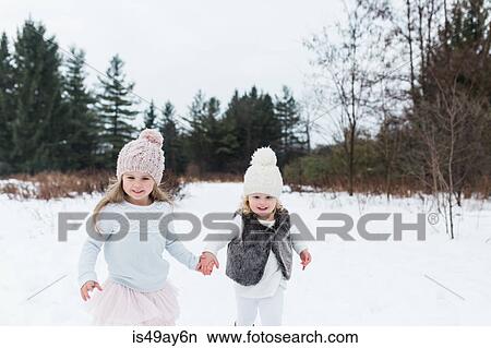 Sisters in snow-covered park, Oshawa, Canada View Large Photo Image Picture - Sisters in snow-covered park, Oshawa, Canada. Fotosearch