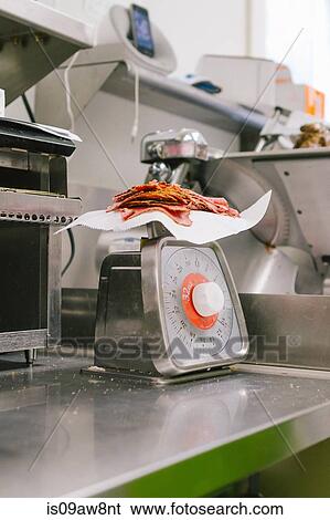Sliced deli meat on scale in general store View Large Photo Image Stock Photograph - Sliced deli meat on scale in general store. Fotosearch