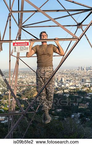 Soldier wearing combat clothing doing chin ups on electricity pylon, Runyon Canyon, Los Angeles, California, USA View Large Photo Image Stock Image - Soldier wearing combat clothing doing chin ups on electricity pylon, Runyon Canyon, Los Angeles, California, USA. Fotosearch