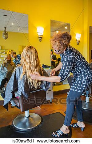 Stylist cutting woman's hair in hair salon View Large Photo Image Stock Image - Stylist cutting woman's hair in hair salon. Fotosearch