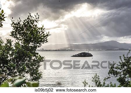 Sunbeams through clouds over sea, Florianopolis, Santa Catarina, Brazil View Large Photo Image Stock Image - Sunbeams through clouds over sea, Florianopolis, Santa Catarina, Brazil. Fotosearch