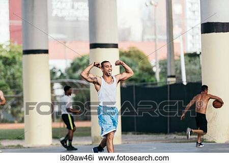 Tattooed man flexing muscles sticking out tongue looking away smiling View Large Photo Image Stock Image - Tattooed man flexing muscles sticking out tongue looking away smiling. Fotosearch