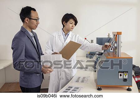Technician explaining printing machine to manager in printing and packaging factory, China View Large Photo Image Stock Image - Technician explaining printing machine to manager in printing and packaging factory, China. Fotosearch