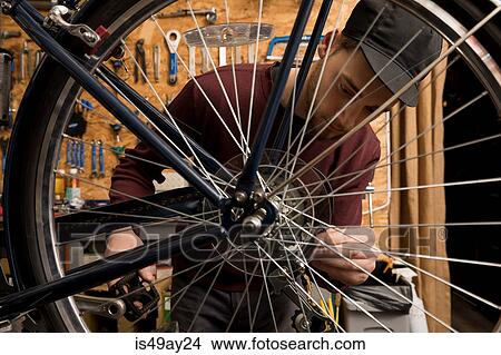Technician in bicycle workshop View Large Photo Image Picture - Technician in bicycle workshop. Fotosearch