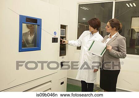 Picture - Technician showing manager printing machine in printing and packaging factory, China. Fotosearch