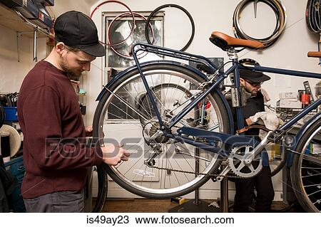 Technicians in bicycle workshop View Large Photo Image Stock Image - Technicians in bicycle workshop. Fotosearch