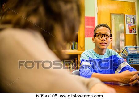 Teenage boy at school speaking to guidance counselor View Large Photo Image Stock Photography - Teenage boy at school speaking to guidance counselor. Fotosearch