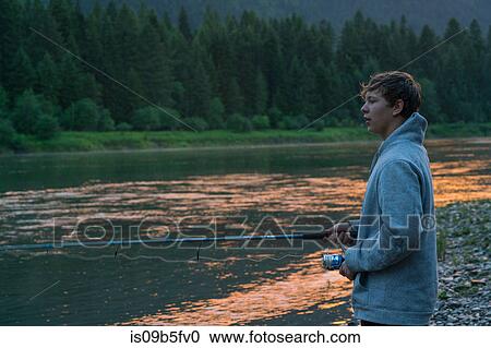 Teenage boy fishing in river at sunset, Washington, USA View Large Photo Image Stock Image - Teenage boy fishing in river at sunset, Washington, USA. Fotosearch