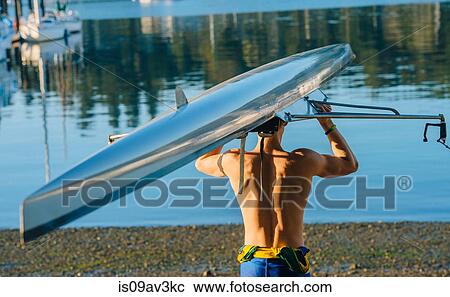 Teenage boy holding sculling boat above head rear view View Large Photo Image Stock Image - Teenage boy holding sculling boat above head rear view. Fotosearch