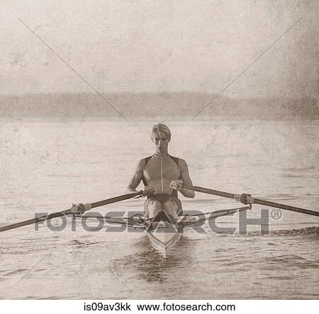 Teenage boy in sculling boat on water View Large Photo Image Stock Image - Teenage boy in sculling boat on water. Fotosearch