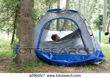 Teenage boy peaking out of tent, Washington, USA View Large Photo Image Stock Photo - Teenage boy peaking out of tent, Washington, USA. Fotosearch