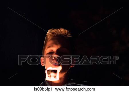 Teenage boy toasting marshmallow View Large Photo Image Stock Image - Teenage boy toasting marshmallow. Fotosearch