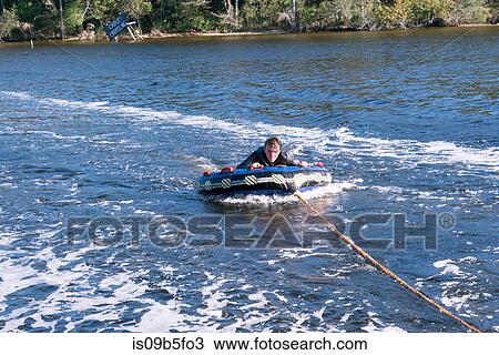 Teenage boy tubing, Poquito Bayou, Shalimar, Florida, USA View Large Photo Image Stock Image - Teenage boy tubing, Poquito Bayou, Shalimar, Florida, USA. Fotosearch
