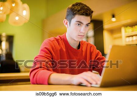 Stock Photograph - Teenage boy using laptop. Fotosearch