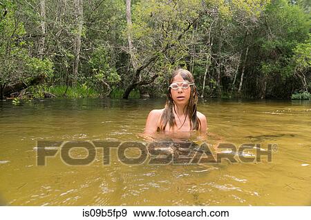 Teenage boy wearing swimming goggles in lake, Niceville, Florida, USA View Large Photo Image Stock Photo - Teenage boy wearing swimming goggles in lake, Niceville, Florida, USA. Fotosearch
