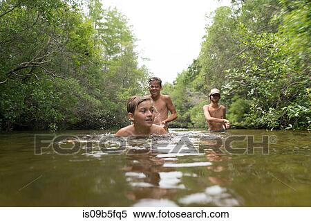 Teenage boys swimming in lake, Niceville, Florida, USA View Large Photo Image Stock Photography - Teenage boys swimming in lake, Niceville, Florida, USA. Fotosearch